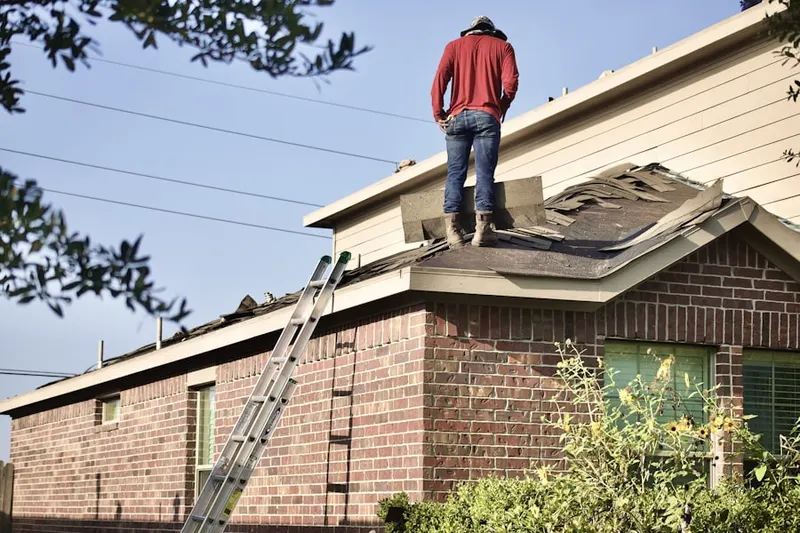 Professional roofer working on a residential roof in Cameron Tract